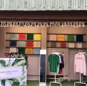Image of Dear Green Claes Barras Market Stall showing garments on rails and brand bunting