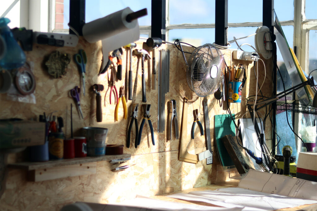 A stain glass window artists bench on a bright day in Glasgow