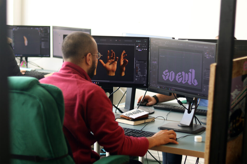 A 3D graphic designer working at a computer